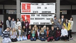 Alexandra Hedrick | Picayune Item  The champs: Members of High Tide Productions drama troupe brave the sleet as they sit beneath their championship banner which has been added to that of the football team. 