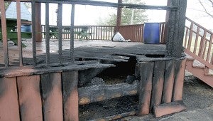 These charred boards on the gazebo at Friendship Park are the result of a fire that is suspected to be related to arson. The fire was reported after the park had closed. The fires occurred in the plastic garbage cans, two of which are visible in the background.