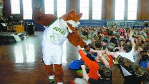 Paw bump: Gutsy the Flying Fox performed at Pearl River Central Elementary schools where he entertained the children while his emcee shared their message of being a student of character who fights bullying, shows respect, and teams up with fellow students.