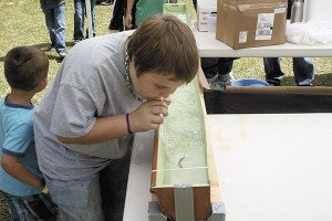 SPRING FUN: Above, a child wins a minnow race by blowing air at the fish through a straw.  Jeremy Pittari | Picayune Item