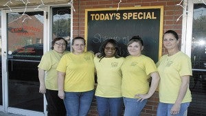 Victoria Fraise, pictured center, stands with the staff of her restaurant that has been serving home made dishes for 17 years.