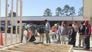 COMMUNITY PARTNERSHIP: High school students watch as Pearl River Community College construction technology student Javier Lopez of Hattiesburg frames a wall. Construction technology is just one of many career courses PRCC offers.  PRCC Public Relations Photo 