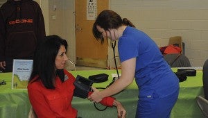 STAYING HEALTHY: Pearl River County School District Vocational Director Kelli Beech has her blood pressure taken by a Health Sciences student at Tuesday’s Family Health Fair.  Photo by Alexandra Hedrick 