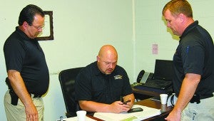 Picayune Police officers Ricky Frierson, Jeremy Magri and Lane Pittman check Facebook responses to the missing person case. Jodi Marze | Picayune Item 