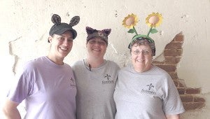 NAWLINS WITH A SMILE: From left, Sarah Hebert, Chemin Pitre and Mary Jo Marsh serve up New Orleans style cuisine with crazy headbands and a smile at Scooters on Main Street in Poplarville.  Photo by Alexandra Hedrick 