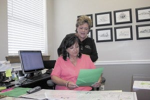PREP WORK: Picayune Main Street Inc. manager Reba Beebe and Street Festival co-chair Eileen Baker prepare for this weekend’s Street Festival. Photo by Jeremy Pittari