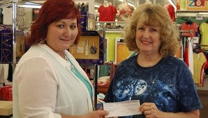 COMMUNITY SUPPORT: From left— Stage store manager Linda Reed presents Pearl River County SPCA representative Maria Diamond with a check for $1,228 for the shelter.  Reed said the store chooses one local non-profit for a program called “30 Days of Giving” and the employees chose the PRC SPCA to be the recipient. Jodi Marze | Picayune Item