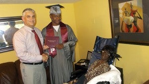 SHARED MOMENT WITH A PROUD GRANDMOTHER: A grandmother’s desire to see her only grandson receive his high school diploma became a reality.  Mrs. Patricia “Pat” Rayford-Satcher has one daughter (Kalela) and one grandson (Dekeilen). Due to illness,  Rayford-Satcher was unable to attend the graduation ceremony on Thursday night. Superintendent Dean Shaw took time out of his busy schedule to present Dekeilen Rayford with his high school diploma at his grandmother’s house on Friday, May 23.  The family is grateful to Mr. Shaw for showing compassion; he was truly an angel that granted a grandmother a memorable moment. Photo submitted
