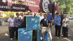 UNVEILING OF RECYCLING UNITS: Shown from left are city officials and civil leaders: Shirley Wiltshire, Alderwoman, Gwen Smith,  PRCC Director Career and Technical Education; Daniel Smith, PRCC Commercial During Instructor;  Blair Sampson, USDA; Ned Edwards, USDA; Mayor Brad Necaise,  Smith,  Byron Wells, Alderman; Ann Bosworth, Poplarville High School; Jason Pearson,  Alderman; and Elvia Edwards, Poplarville Woman's Club. Not shown is Stacy Wilkes of Poplarville Rotary Club. Photo submitted