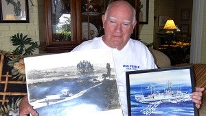 Former POW : Dick Tuck shows his two prized pieces of art. The photo on the left is of the bridge he crossed when he was released back to the United States government after 11 months as a prisoner of  war with fellow crewmembers of the USS Pueblo. The second, is a painting of the USS Pueblo which is signed by the artist, Capt. Lloyd “Pete” Bucher, the former captain of the ship when it was taken over by enemy forces. Bucher was forced to sign a false confession to save his men’s lives. Jodi Marze | Picayune Item