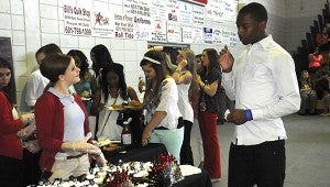 CELEBRATE: A member of the Picayune Memorial High School student council asks a senior what cupcake they want at the senior luncheon Monday.  Photo by Alexandra Hedrick 