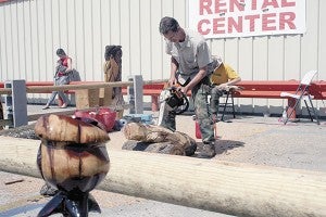 CHIPPING AWAY: James Seal was at Phillips Building Supply Thursday selling and creating his brand of chainsaw art. Photo by Jeremy Pittari