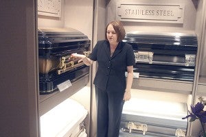 FRACTIONAL DISPLAY: Henrietta Brewer shows off Picayune Funeral Home’s fractional casket display. It allows the business to showcase more options, and also avoid the uncomfortable nature of grieving families viewing full caskets. Photo by Jeremy Pittari