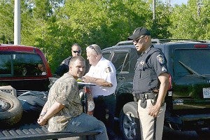 The two suspects wanted in connection with a stabbing and carjacking earlier this week have been arrested. They will be extradited to Pearl River County where they will face a number of charges. In this photo, officers arrest Jacob McTaggart. Photo by Dwayne Bremmer, Sea Coast Echo