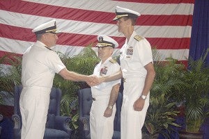 INCOMING LEADER: Pictured center, outgoing Rear Admiral Brian Brown turned over command of the Naval Meteorology and Oceanography Command to Rear Admiral Timothy Gallaudet, pictured at right. Photo by Jeremy Pittari