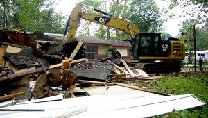 Jesse Wright | Picayune Item tearing down: City workers tear down a house on Nixon Street Tuesday. The home is on school district property, and the city is helping the district clean up its properties. 