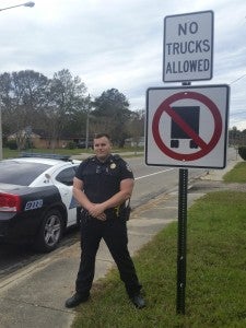 NEW SIGNAGE: The City of Picayune Public Works Department recently added these new signs at both ends of Bruce Street to indicate the fact that the residential area is a no truck zone. Picayune Police Department Sgt. Matt Roberts is pictured with one of the new signs. Photo submitted 