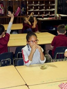 A first-grader at Roseland Park Elementary School enjoys some kiwi.